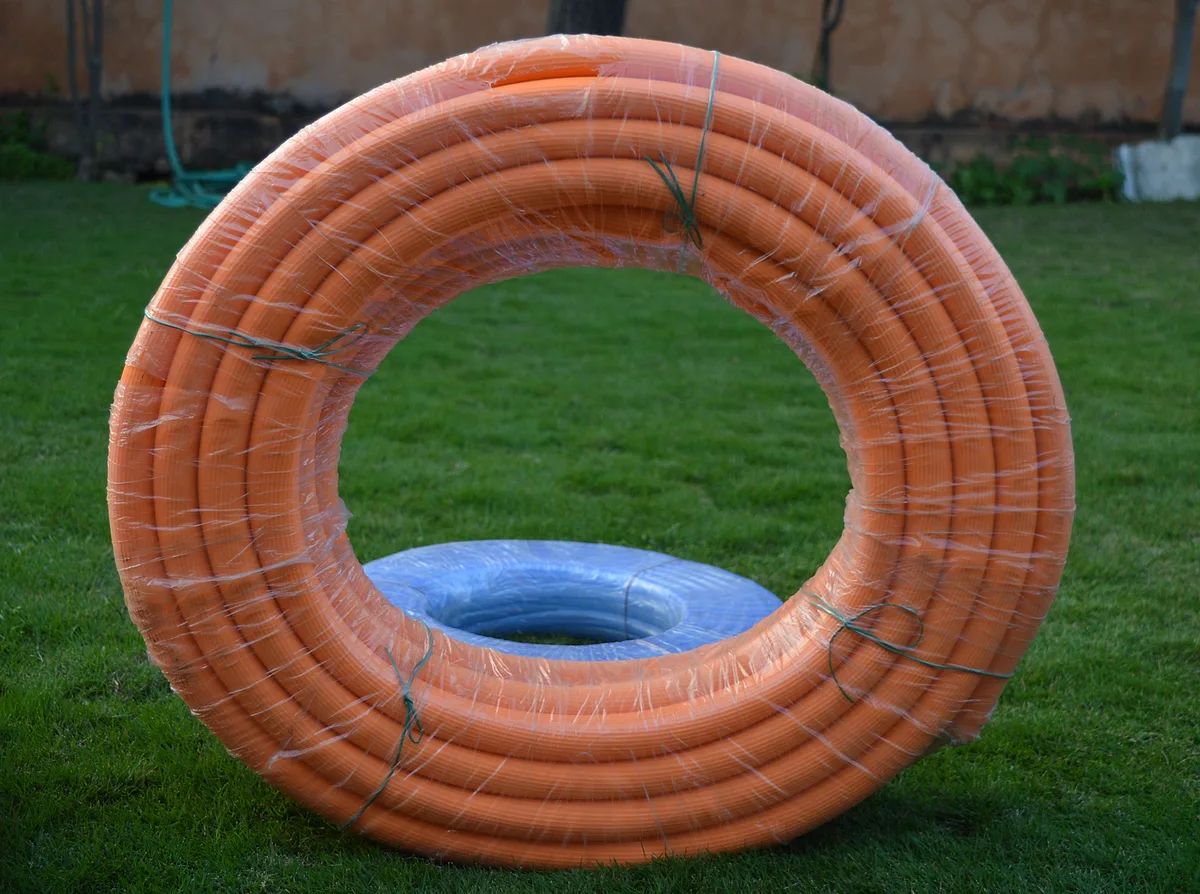 Orange ribbed garden pipe coil
