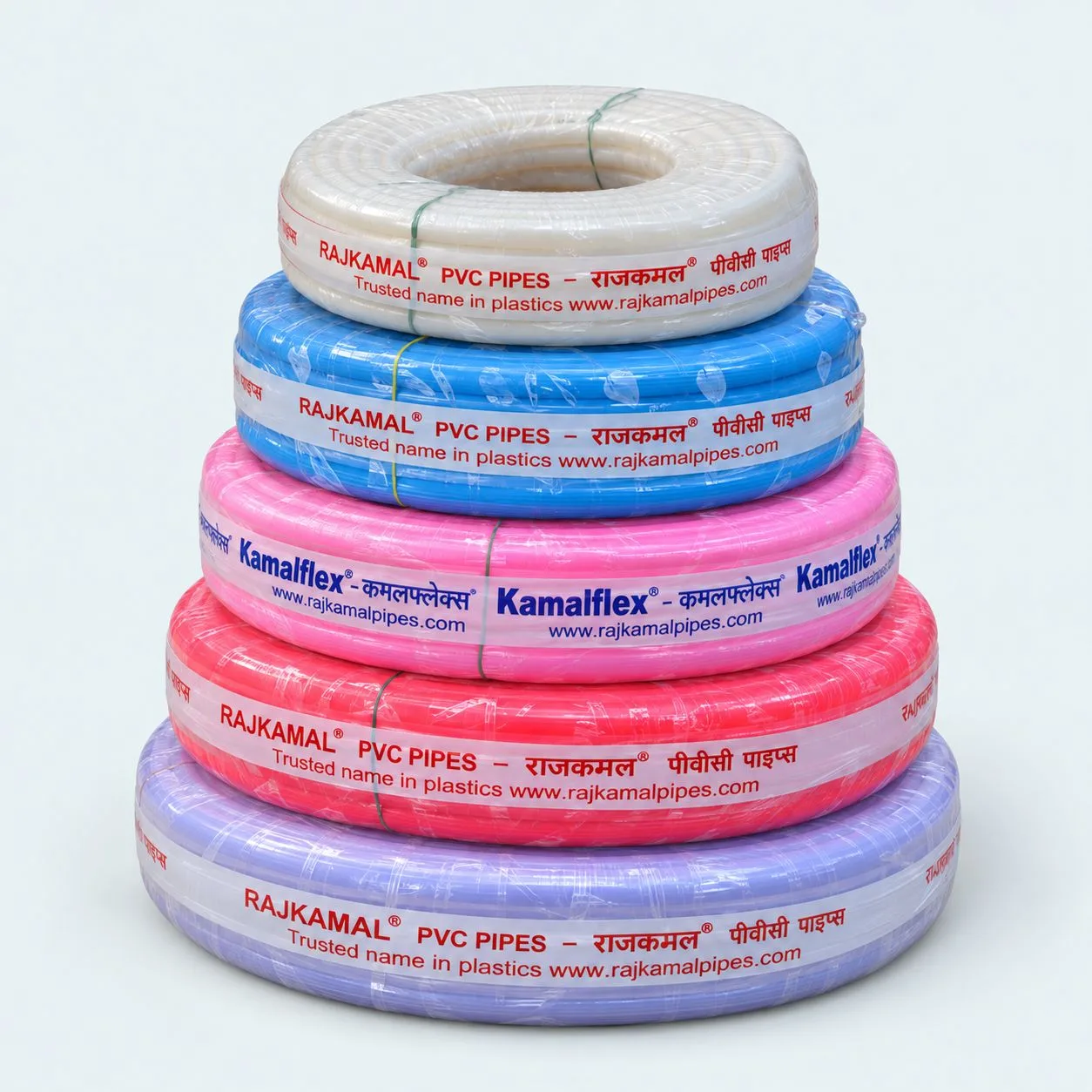 Five stacked Rajkamal and Kamalflex garden pipe coils in white, blue, pink, red and lavender
